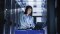 The picture shows a woman working in a data centre