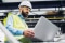 A field technician using a laptop to inspect and monitor HVAC equipment performance, helping optimise maintenance planning and system reliability.
