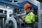 Technician overseeing industrial equipment to support continuous operations and power use.