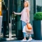 Shopper entering a modern retail store carrying shopping bags