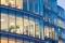 Office building with multiple floors visible through glass windows where climate control maintains a comfortable working environment.