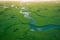 Aerial view: a river flows through a green forest