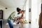 The image shows a woman lovingly interacting with a toddler sitting on the kitchen counter.