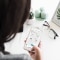 The image shows a woman that is using the Carrier app on her smartphone